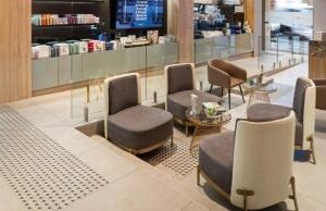 Large, light beige floor tiles are neatly laid throughout this modern waiting area, similar to what you might find in a Chatswood cafe