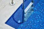The vibrant blue mosaic tiling in this pool could easily be found in a backyard oasis in Bondi