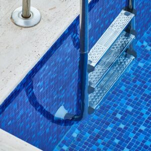 The vibrant blue mosaic tiling in this pool could easily be found in a backyard oasis in Bondi